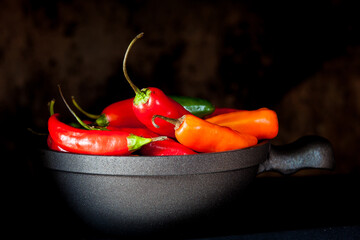 Red hot chili peppers on black background