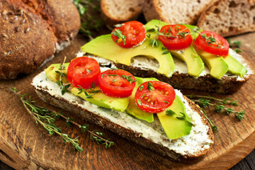 Toast with cream cheese, avocado and cherry tomatoes