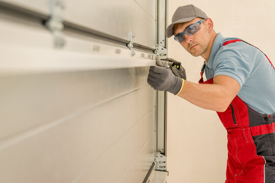 Installing Brand New Residential Garage Doors by Professional Technician