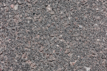asphalt texture with small stones in dark gray color