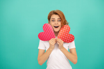 shocked young girl with red heart on blue background
