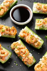 Cucumber Shrimp Sushi Boats with Spicy Mayo, Rice, Chives and sesame seeds