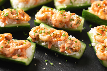 Cucumber Shrimp Sushi Boats with Spicy Mayo, Rice, Chives and sesame seeds