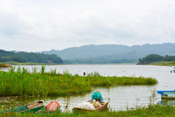 Overhead view of fishing gear, wooden boat, fishing nets, fishing tackle. View by the lake