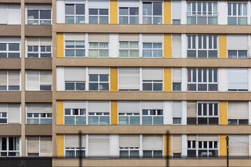 Facade of a constructivist house with windows in the style of the seventies with yellow panels