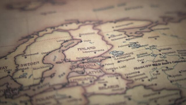 Finland on a vintage political world map. Slow motion, tracking arc shot. 