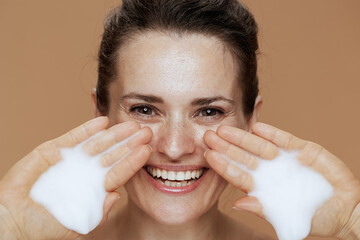 happy modern 40 years old woman washing face