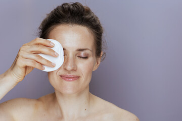 relaxed modern woman with cotton pad on blue