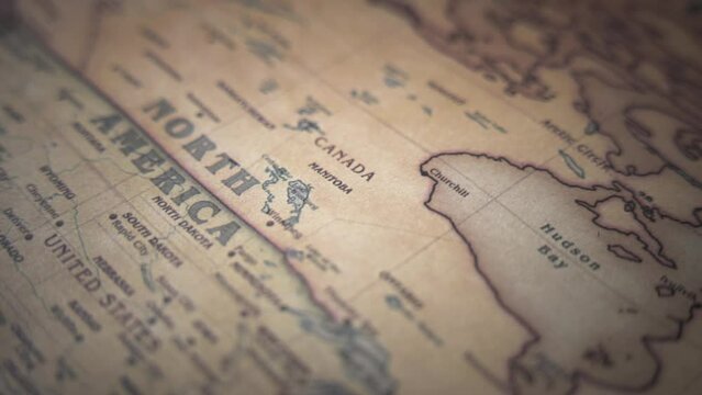 Canada and North American continent on a vintage political world map. Slow motion, tracking arc shot.  