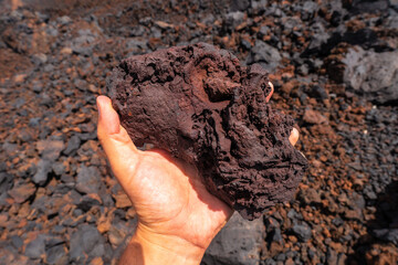 Detail of the red stones on the volcanic trail in the town of Tamaduste on the coast of the island of El Hierro, Canary Islands, Spain