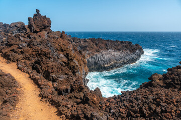 Fototapeta na wymiar Volcanic trail in the village of Tamaduste on the coast of the island of El Hierro, Canary Islands, Spain