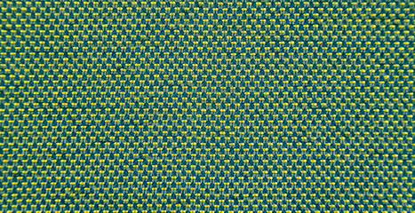 Close-up of green stitched with yellow threads. Green texture background.