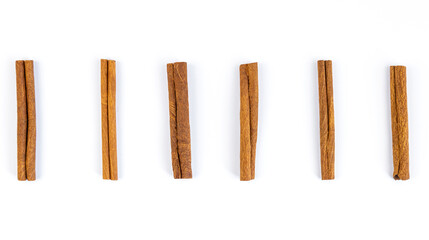 Set of cinnamon sticks isolated on white background. View from above.