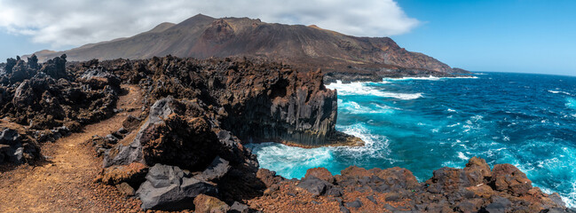Fototapeta na wymiar Panoramic of the cliffs with volcanic stones in the town of Tamaduste on the island of El Hierro, Canary Islands, Spain