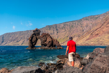 A tourist man at the Roque de la Bonanza on the island of El Hierro, Canary Islands, Spain