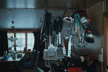Naklejka na ściany i meble detail of a steel kitchenware hanging in modern kitchen, mixed light Generative AI