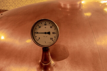 vintage pressure gauge on copper brewing still 