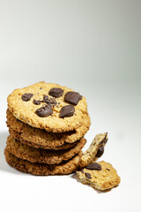 Handmade cookies for a healthy breakfast. Homemade oatmeal cookies with dark chocolate on a light background.