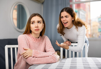Girlfriend or sister yelling at girl during family quarrel at home Generative AI - obrazy, fototapety, plakaty