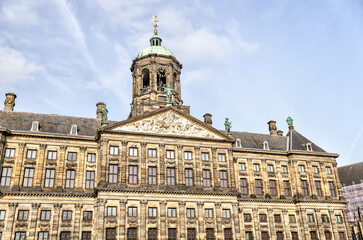 Amsterdam, Netherlands - March 28, 2023: The Royal Palace and the New Church surrounding Dam Square in Amsterdam
