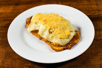 Fried patacon with shredded chicken with cheese - Colombian street food