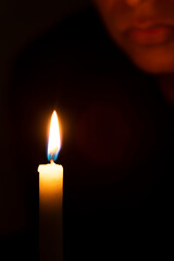 person lit by a candle