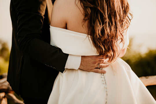 wedding details for bride and maid of honor groom getting married pink and white bathrobes preparations bridesmaids wedding day dress white rings	
