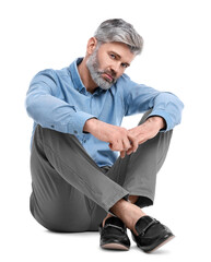 Mature businessman in stylish clothes sitting on white background