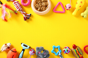 Frame of different pet toys and training accessories on yellow background. Flat lay, top view. Pet shop banner template.