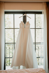 bride and groom getting ready for wedding day holding hands wedding day ring bouquet with flowers in white wedding dress marriage pink robes slippers 