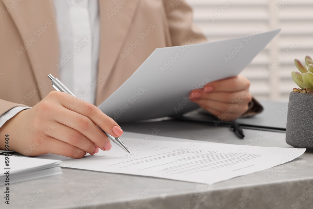 Canvas Prints Woman signing document at table, closeup view