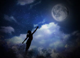 Obraz na płótnie Canvas Sleepwalking condition. Silhouette of girl reaching to moon on starry night