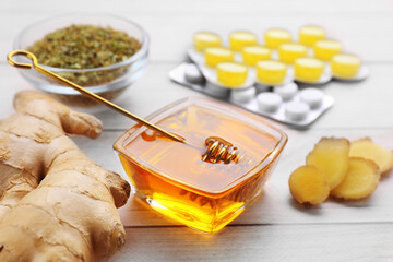 Cold remedies and pills on white wooden table, closeup. Cough treatment