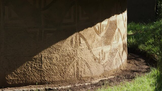 Geometric designs etched into plaster wall of Lesotho round house