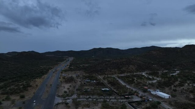 aerial shot of drone flying over road or highway in cloudy day