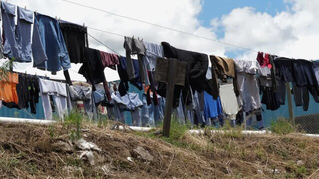 Clean clothes dry in sunshine on washing lines in Lesotho work camp