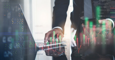 Businessman working with stock market investment, using laptop computer analyzing trading data with stock exchange graph on screen. Financial stock market trade, currency exchange.