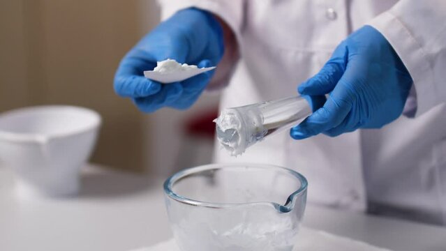 A cream is mixed by an Pharmaceutical assistant