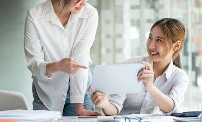 Two young businesswoman working together. Businesswoman advisor, business people talking, planning analyze investment