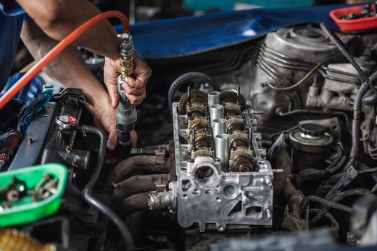 Car engine repair and service in garage service shop.