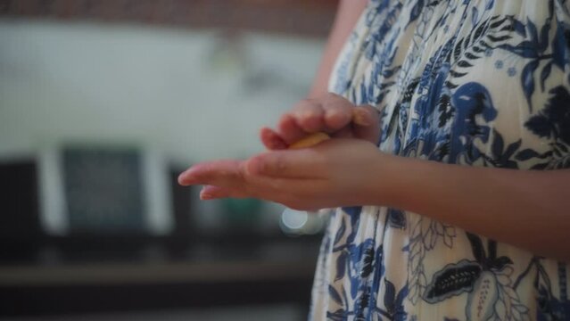 Female chef rolling traditional Brazilian cheese bun in her hands. Slow motion, shallow depth of field.  