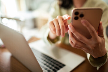 Young Japanese woman using a smart phone in the living room