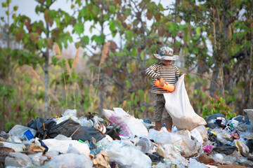 Poor children collect and sort waste for sale, concepts of poverty and the environment.