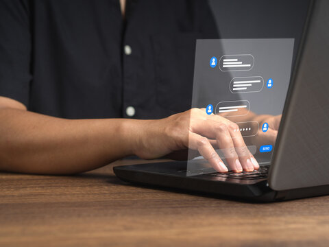 Man typing on a keyboard laptop with live chat chatting on application communication digital media websites and social network
