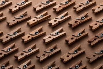 Top View of Wooden Clothespins Isolated on Brown Paper Background