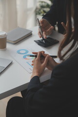 Financial analysts analyze business financial reports on a digital tablet planning investment project during a discussion at a meeting of corporate showing the results of their successful teamwork.