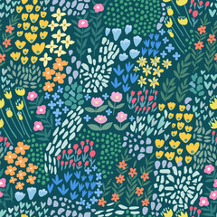 A pattern of abstract bright spring and summer flowers on a green background.