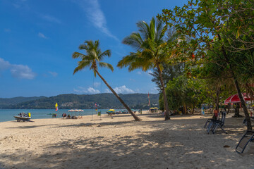 Patong Beach Phuket Thailand nice white sandy beach clear blue and turquoise waters and lovely blue skies with Palms tree