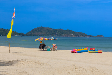 Fototapeta premium Patong Beach Phuket Thailand nice white sandy beach clear blue and turquoise waters and lovely blue skies with Palms tree