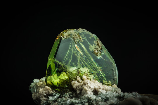 green titanite (also called sphene). macro detail texture background. close-up raw rough unpolished semi-precious gemstone
